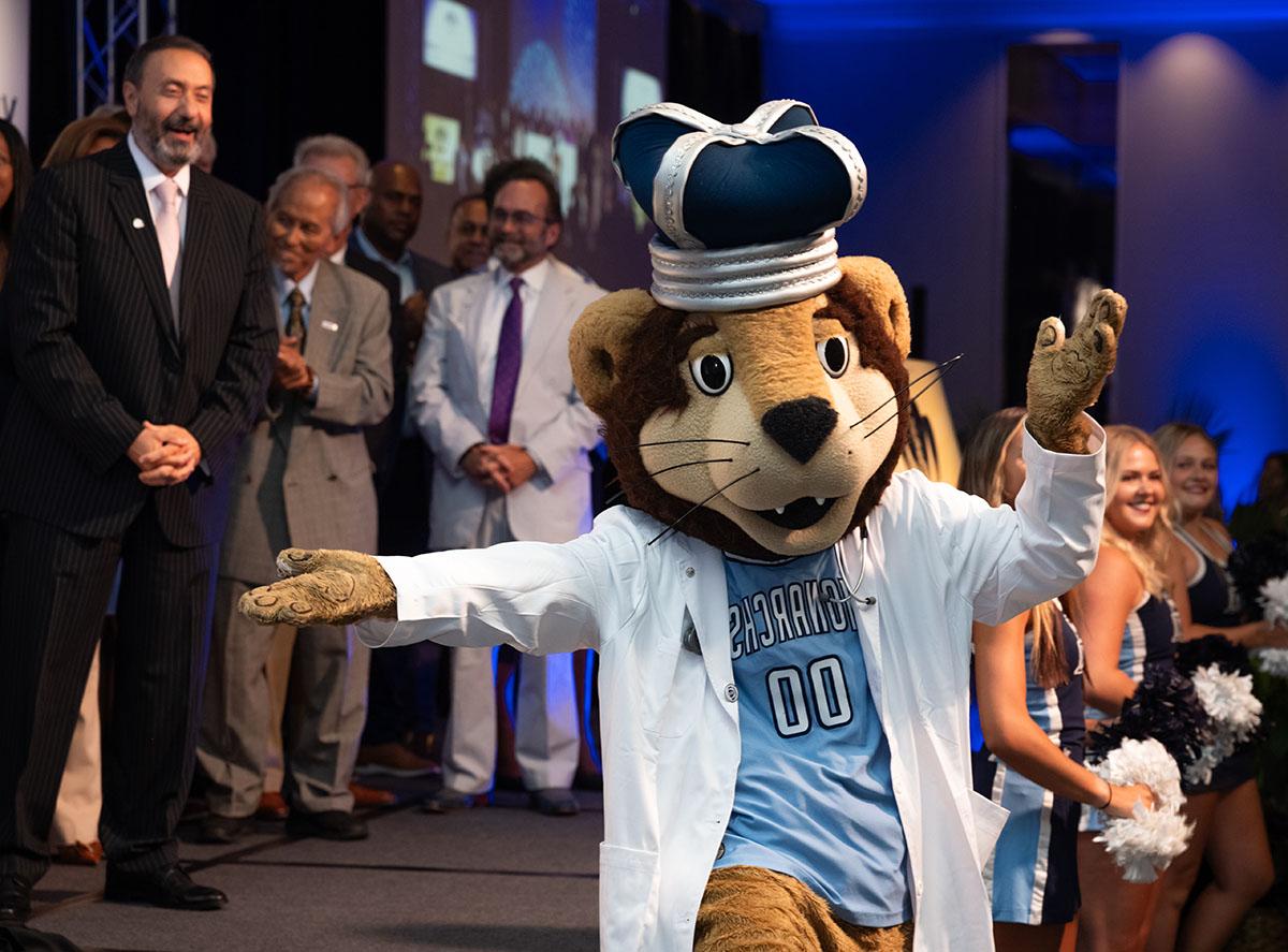 Photo of ODU's mascot dancing in front of a group of people.